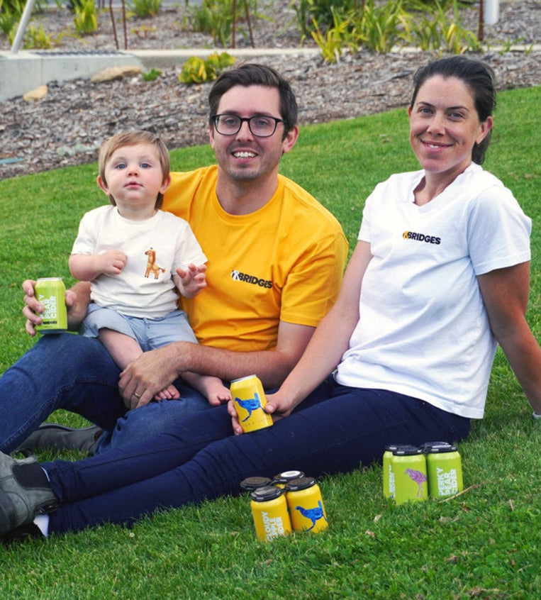 Mr Bridges Family sitting on the grass with cider