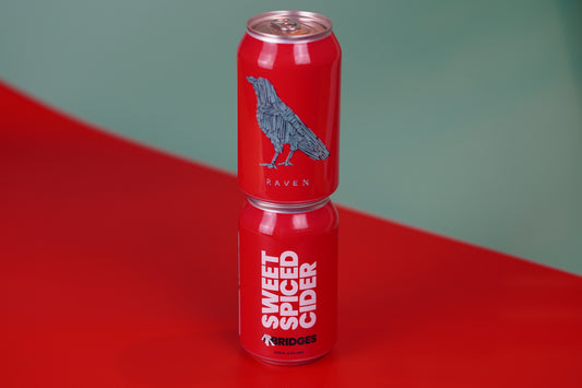 Two Cans of Mr Bridges red 'Sweet Spiced Cider' cans with raven artwork. 